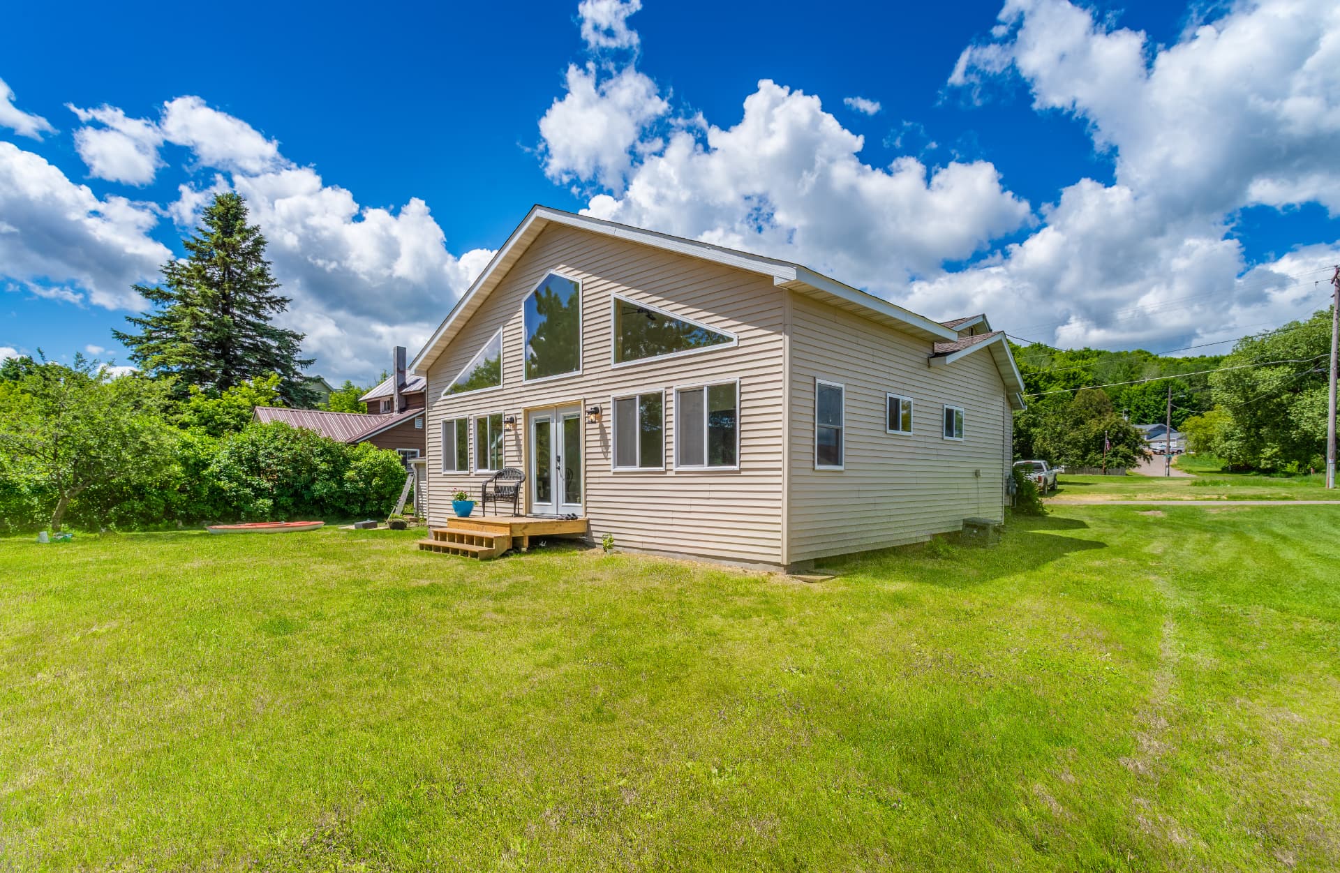 Rear exterior of the Ishpeming home addition with new entry deck and steps
