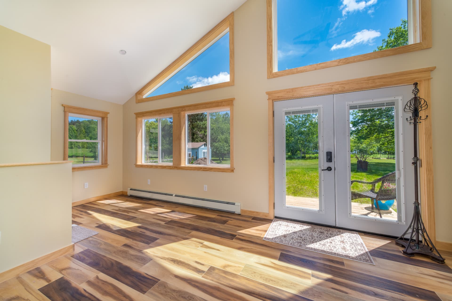 Vaulted living space with triangle gable windows and patio doors in an Ishpeming, MI room addition