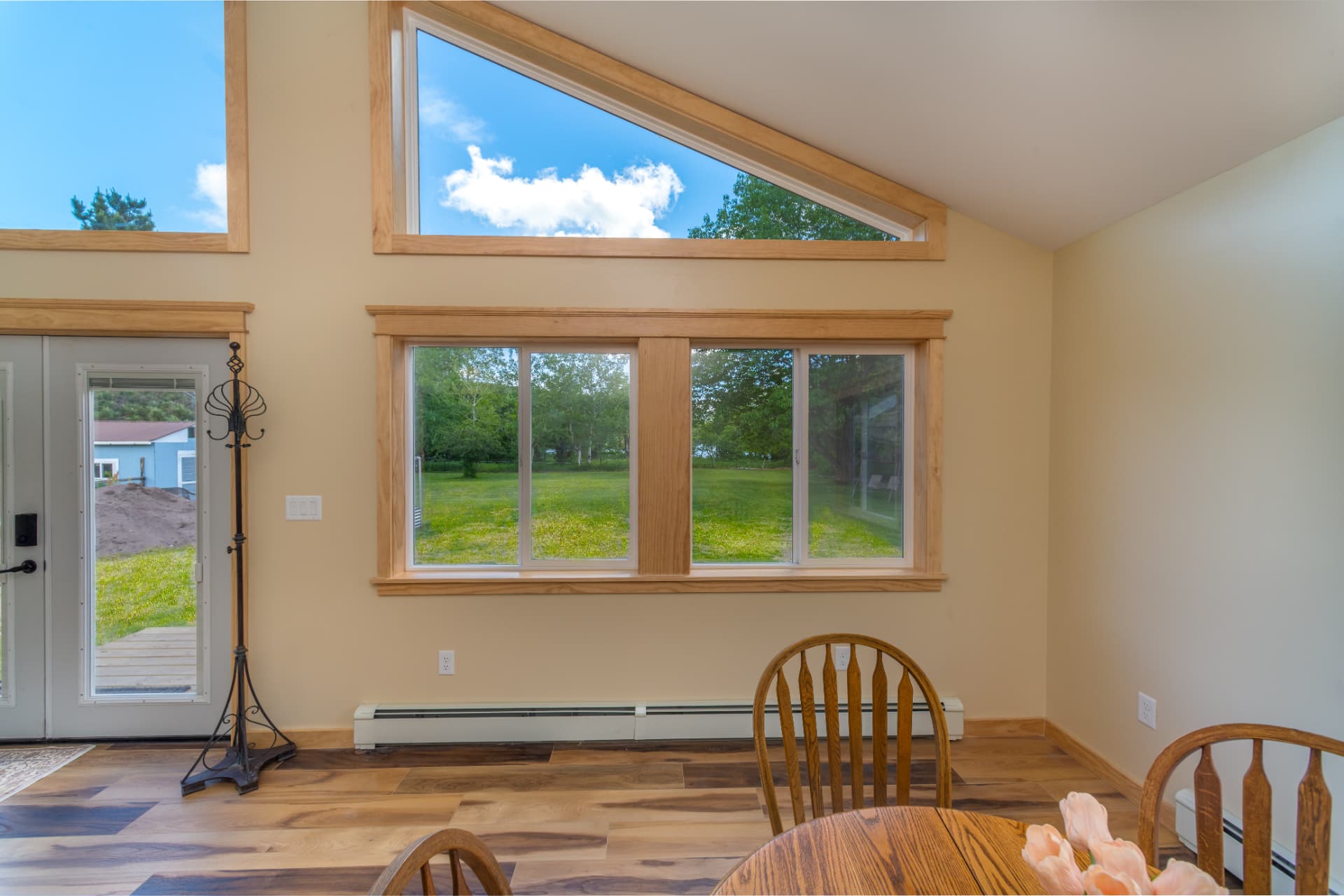 New sliding windows with oak trim and patio door in an Ishpeming room addition
