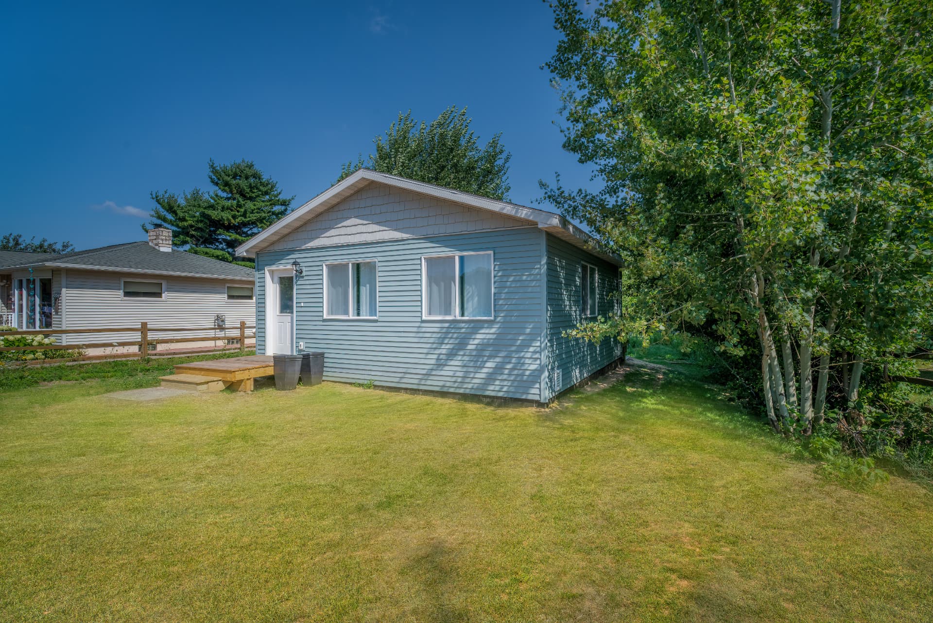 Side view of new build guest house with siding and shingled gable in Marquette County