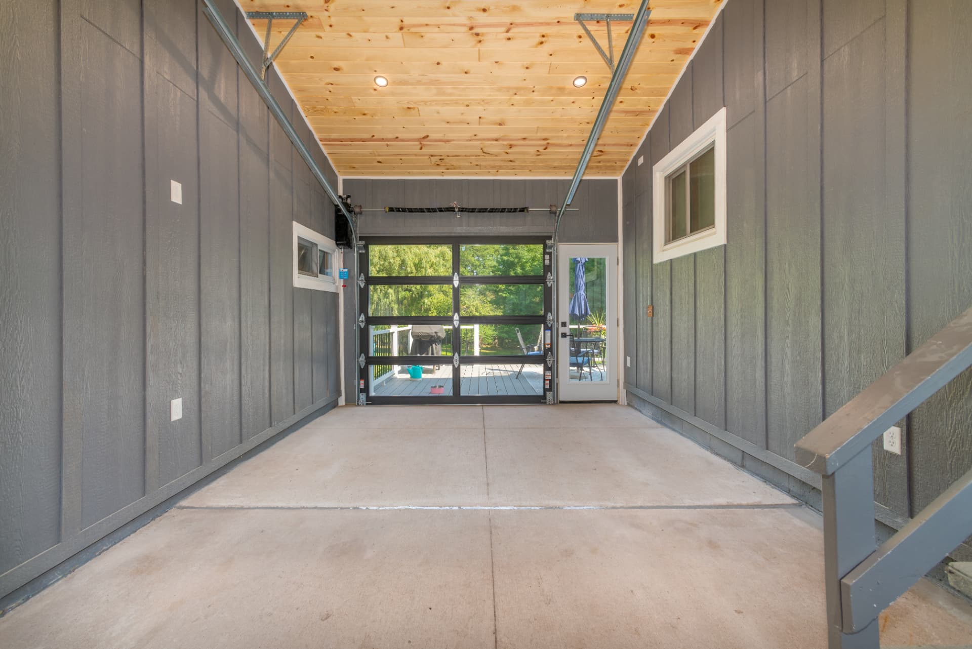 Interior of the custom breezeway with cedar tongue and groove ceiling and glass garage door in Marquette, MI