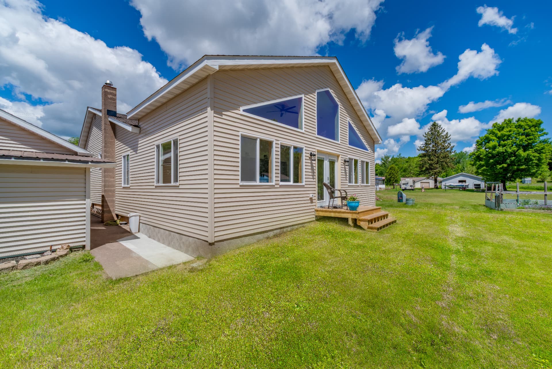 Exterior side view of the new addition with matching siding and gable windows in Ishpeming, MI