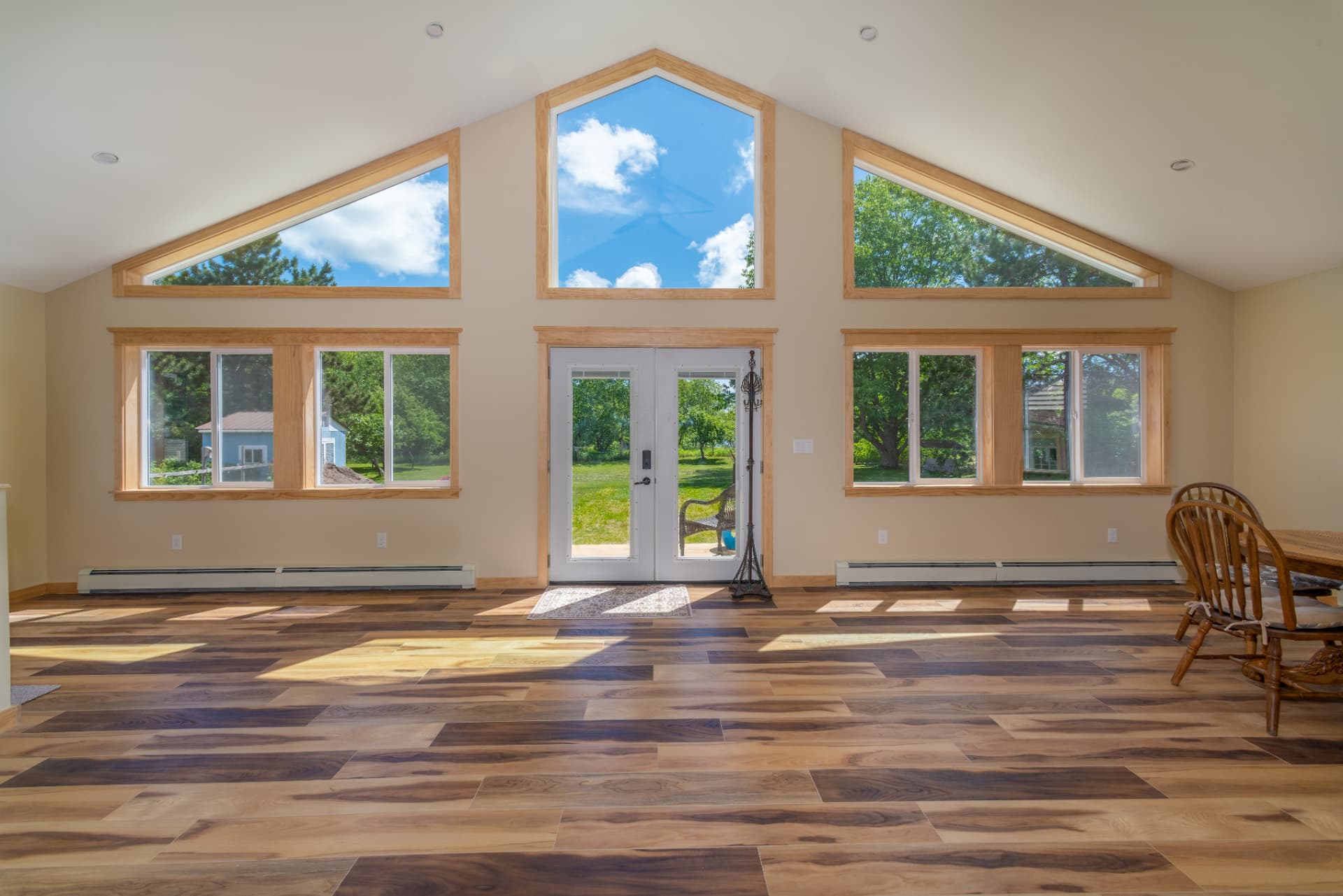 Wide interior view of the finished addition with hickory flooring and hardwood trimmed windows in Ishpeming, MI