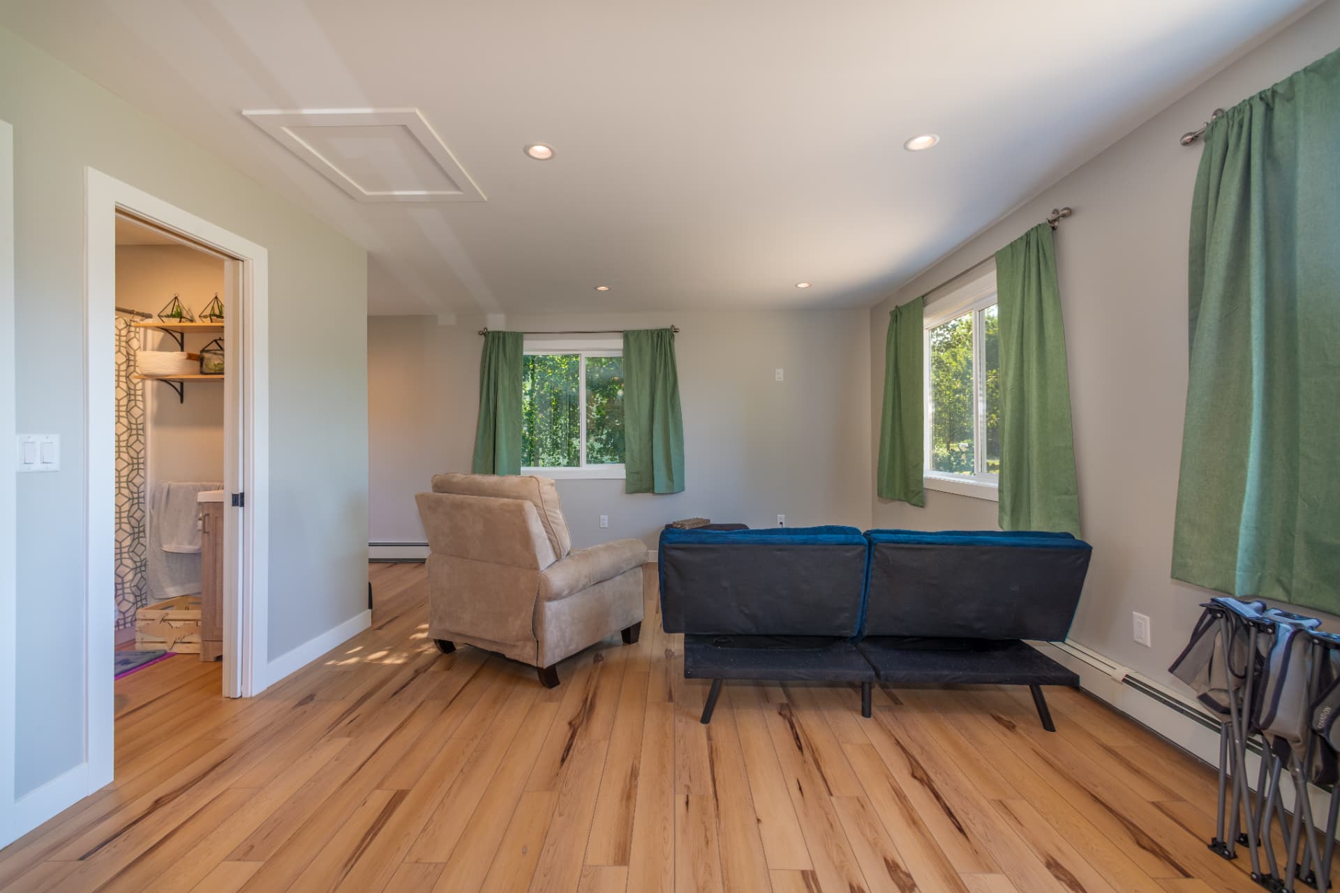 Open living room with hickory flooring and recessed lighting
