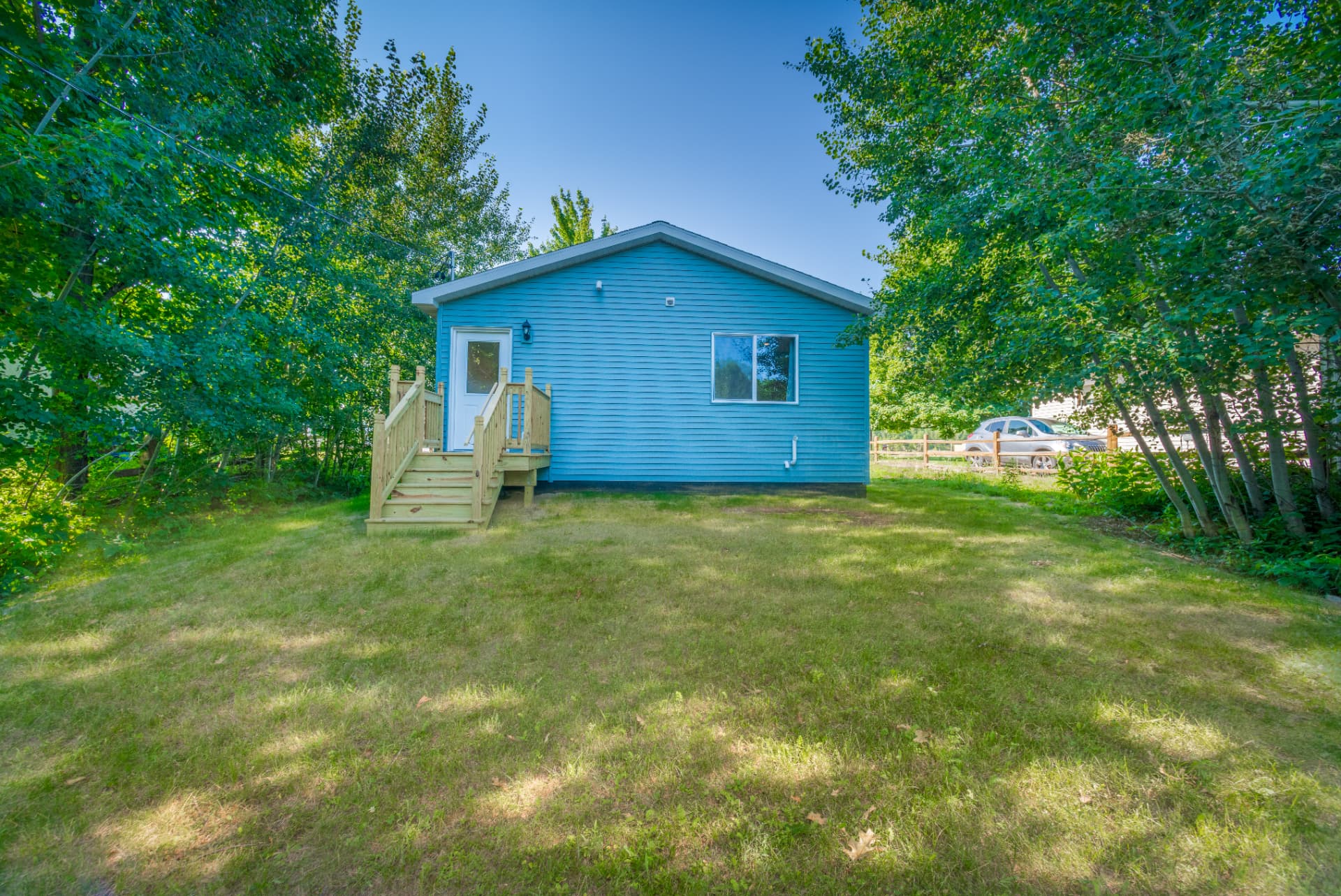 Blue sided new construction guest house with treated stairs in Marquette, MI