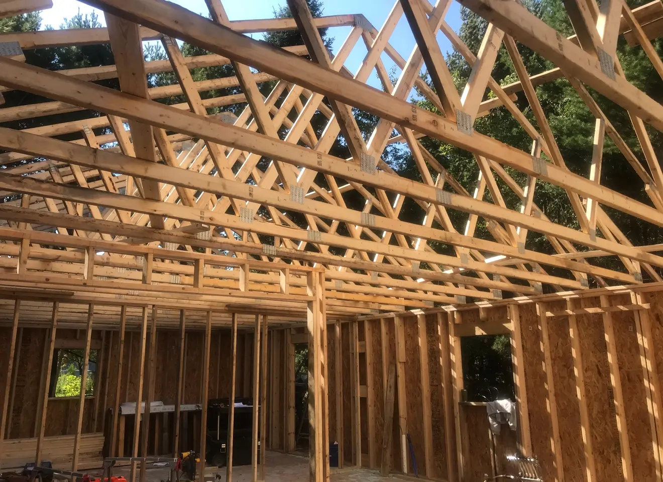 New home framing with roof trusses and wall studs during construction in Marquette, Michigan