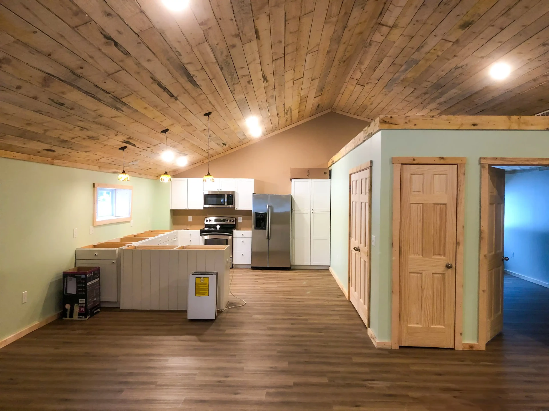 Custom home interior with rustic wood ceiling and kitchen in Marquette, Michigan
